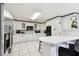 Functional kitchen featuring white cabinets, modern appliances, and a practical breakfast bar at 200 W Louisiana Ave, Tampa, FL 33603