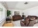 Bright living room with tile floors, leather furniture, and a large window at 200 W Louisiana Ave, Tampa, FL 33603