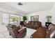 Inviting living room with tile flooring, comfortable leather seating, and a bright window at 200 W Louisiana Ave, Tampa, FL 33603