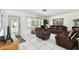 Bright living room with tile floors, leather furniture, and a decorative front door at 200 W Louisiana Ave, Tampa, FL 33603