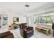 Bright living room with tile flooring, modern furniture, and natural light from the window at 200 W Louisiana Ave, Tampa, FL 33603