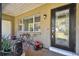 Cozy porch area with seating, plants, and a decorative front door at 200 W Louisiana Ave, Tampa, FL 33603