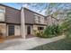 Inviting exterior of a multi-story home with lush landscaping, twin balconies, and prominent front doors at 10607 Carrollbrook Way # 10607, Tampa, FL 33618