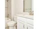 Bathroom with shower-tub combo, white vanity with countertop, decorative mirror, and white toilet at 10714 Torchwood Sea Way, San Antonio, FL 33576