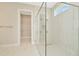 Spacious shower with glass enclosure and walk-in closet in bathroom at 10714 Torchwood Sea Way, San Antonio, FL 33576