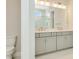 Bathroom with double sink vanity and separate toilet at 10714 Torchwood Sea Way, San Antonio, FL 33576
