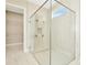 Large glass enclosed shower and walk in closet in bathroom at 10714 Torchwood Sea Way, San Antonio, FL 33576