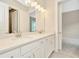 This bathroom features a double vanity with quartz countertops, stylish lighting and framed mirror at 10714 Torchwood Sea Way, San Antonio, FL 33576