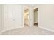 This bedroom features a view of the ensuite bathroom and carpet flooring at 10714 Torchwood Sea Way, San Antonio, FL 33576