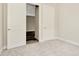 Bedroom featuring plush carpet, a window, base molding, and a view into the closet at 10714 Torchwood Sea Way, San Antonio, FL 33576