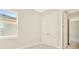 This bedroom has a closet with double doors and features views to other rooms in the home at 10714 Torchwood Sea Way, San Antonio, FL 33576