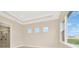 A new bedroom with tray ceiling and view to yard at 10714 Torchwood Sea Way, San Antonio, FL 33576