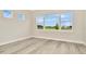 Bright bedroom with views of the lawn and luxury vinyl flooring at 10714 Torchwood Sea Way, San Antonio, FL 33576