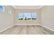 This new bedroom has luxury vinyl flooring and great views of the lawn at 10714 Torchwood Sea Way, San Antonio, FL 33576