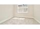 Bedroom with plush carpet, base molding and a window to provide natural light at 10714 Torchwood Sea Way, San Antonio, FL 33576