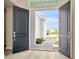 Grand double front doors provide a welcoming entrance and a glimpse of the home's attractive exterior at 10714 Torchwood Sea Way, San Antonio, FL 33576