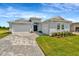 Charming single-story home with a paved driveway, well-manicured lawn, and inviting double-door entryway at 10714 Torchwood Sea Way, San Antonio, FL 33576