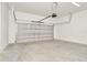 Spacious garage with concrete flooring and an automatic door opener at 10714 Torchwood Sea Way, San Antonio, FL 33576
