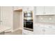 Modern kitchen with stainless steel microwave and oven plus white cabinetry at 10714 Torchwood Sea Way, San Antonio, FL 33576