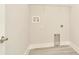 Bright laundry room with wood-look flooring and wire shelving at 10714 Torchwood Sea Way, San Antonio, FL 33576