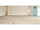 Bright, airy living room features wood-look tile flooring and entry view at 10714 Torchwood Sea Way, San Antonio, FL 33576