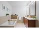 Well-lit bathroom with double vanity, soaking tub, and neutral tiles provides a relaxing space at 111 N 12Th St # 1314, Tampa, FL 33602
