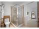 Modern bathroom features a glass-enclosed shower, toilet, and doorway to the Primary bedroom at 111 N 12Th St # 1314, Tampa, FL 33602