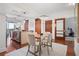 Modern dining room with a glass table, four chairs, and wood floors at 111 N 12Th St # 1314, Tampa, FL 33602