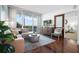 Bright living room features hardwood floors, comfortable seating, and a sliding glass door to the balcony at 111 N 12Th St # 1314, Tampa, FL 33602