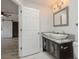 Lovely bathroom featuring a double-sink vanity with granite countertops and modern lighting at 112 Rose St, Venice, FL 34293