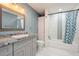 Bathroom featuring a granite countertop, tub, and a stylish blue and white shower curtain at 112 Rose St, Venice, FL 34293