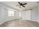 Bedroom featuring wood-look floors, a barn door, a modern ceiling fan and natural light at 112 Rose St, Venice, FL 34293