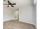 Spacious bedroom boasting wood-look floors and an adjoining ensuite bathroom at 112 Rose St, Venice, FL 34293