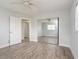 Bedroom with wood flooring, a ceiling fan, closet with mirrored doors and access to another room at 112 Rose St, Venice, FL 34293