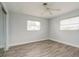 This bedroom boasts stylish wood flooring, a ceiling fan, and two windows that fill it with natural light at 112 Rose St, Venice, FL 34293