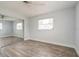 Charming bedroom with wood flooring, a ceiling fan, a closet with mirrored doors and a sun-filled window at 112 Rose St, Venice, FL 34293