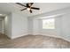 Open bedroom featuring wood-look floors, a modern ceiling fan and natural light at 112 Rose St, Venice, FL 34293