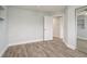 Bedroom with wood flooring, closet with mirrored doors, and access to another room at 112 Rose St, Venice, FL 34293