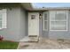 Inviting front door with glass detailing and modern lighting, complemented by manicured landscaping at 112 Rose St, Venice, FL 34293
