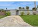 Quaint single-story home with a well-maintained lawn, framed by mature landscaping for added privacy at 112 Rose St, Venice, FL 34293