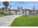 Inviting single-story home with a lush green lawn and a convenient driveway leading to the entrance at 112 Rose St, Venice, FL 34293
