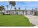 Charming single-story home with a well-manicured lawn, complemented by palm trees for a tropical touch at 112 Rose St, Venice, FL 34293