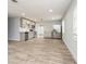 Spacious kitchen with stainless steel appliances, white cabinets, tile backsplash and wood flooring at 112 Rose St, Venice, FL 34293