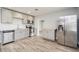 Beautiful kitchen with gray cabinets, stainless appliances, and wood-look flooring at 112 Rose St, Venice, FL 34293