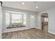 Inviting living room showcases wood-look floors, archway, and a cozy window seat with vibrant pillows at 112 Rose St, Venice, FL 34293