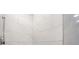 This walk-in shower features stylish white tiles and a shower head at 112 Rose St, Venice, FL 34293