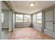 Enclosed sunroom boasting tile floors, multiple windows and access to the backyard at 112 Rose St, Venice, FL 34293