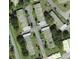 An aerial view shows multiple condo buildings with designated parking spots and surrounding landscaping in a community at 11204 Pembridge Ct # 5, Port Richey, FL 34668