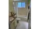 Retro bathroom with a tub, tile flooring, green vanity, and framed mirror at 11251 80Th Ave # 210, Seminole, FL 33772