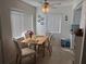Bright dining area features a ceiling fan, large windows, dining table, and floral chairs at 11251 80Th Ave # 210, Seminole, FL 33772